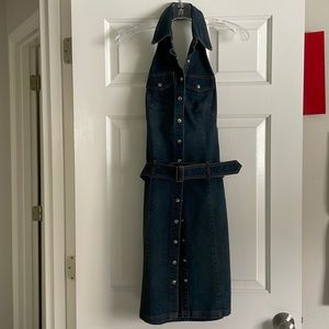 Distressed blue denim shift dress, with belt; pearlized snap buttons; backless.